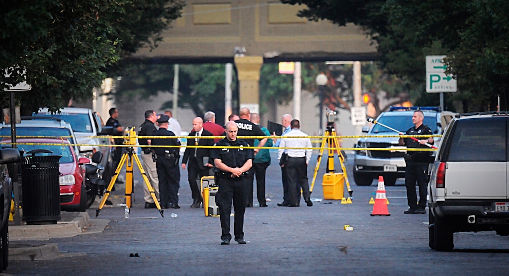 (Marshall Gorby | Dayton Daily News | AP) Dayton police look for evidence after a mass shooting in Dayton, Ohio on Sunday, Aug, 4, 2019.