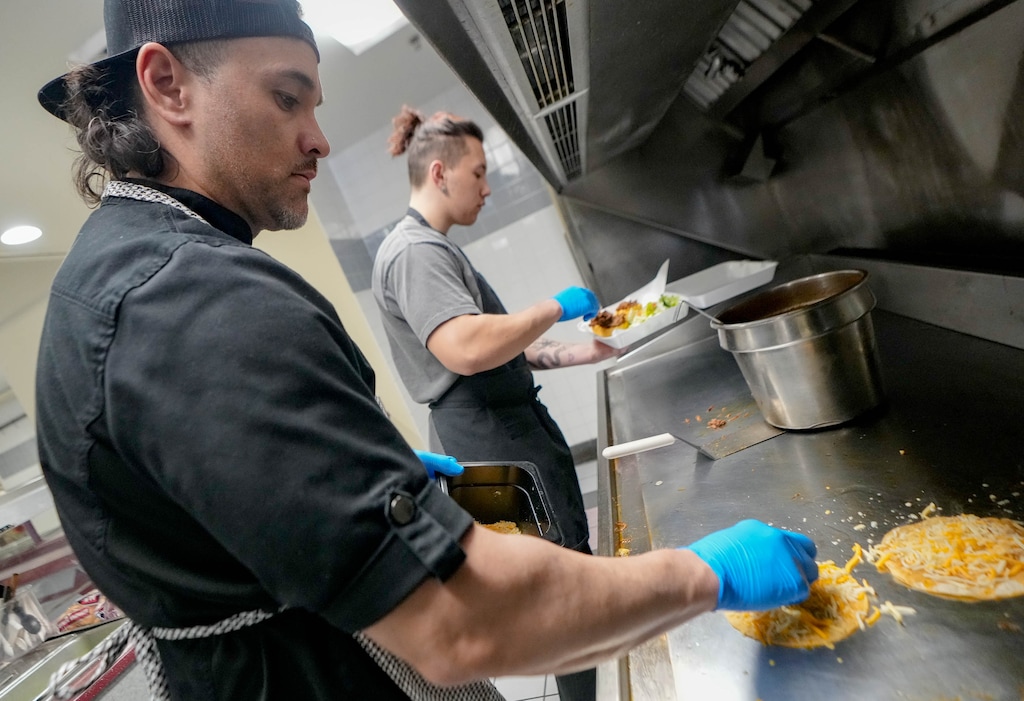 (Francisco Kjolseth | The Salt Lake Tribune) Spencer Langi, left, owner and executive chef of Café Limón prepares birria tacos alongside his son Villiami Langi at the restaurant in West Valley City on Thursday, Feb. 23, 2023. Langi is half Tongan but fell in love with Latin American food, offering a fusion of many cultures.