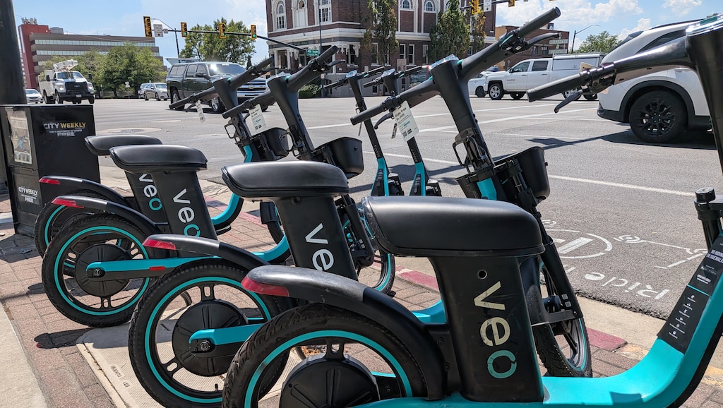 (Paighten Harkins | The Salt Lake Tribune) Veo scooters wait for riders at the intersection of 400 South and 200 West on Thursday, July 23, 2026.