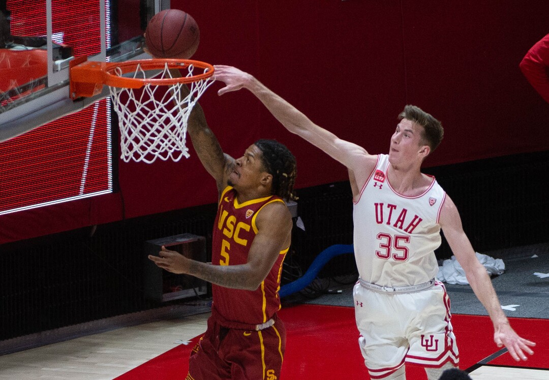 (Francisco Kjolseth  | The Salt Lake Tribune) USC Trojans guard Isaiah White (5) gets defensive pressure from Utah Utes center Branden Carlson (35) in PAC-12 basketball action at the Jon M. Huntsman Center, on Saturday, Feb. 27, 2021.