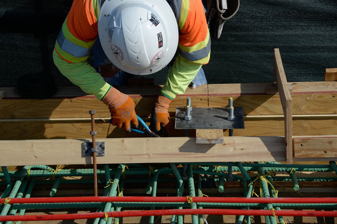 (Francisco Kjolseth  |  The Salt Lake Tribune) UDOT gives a tour of the state’s new longest pedestrian bridge on Thursday, August 20, 2020, connecting Utah Valley University in Orem to student housing and the community on the West side of I-15, as Jose Peralta secures rebar. Crews are finishing up an extensive hydronic heating system that will pump warm water to keep the bridge clear of snow in the winters, as it gets ready to pour concrete for the walking surface. UDOT will close I-15 in both directions this weekend for work on the nearly 1,000 foot bridge that is 15 feet wide to accommodate pedestrians, cyclists and scooters. Elevators and stairs with small ramps to push up bicycles will be on each side of the bridge.