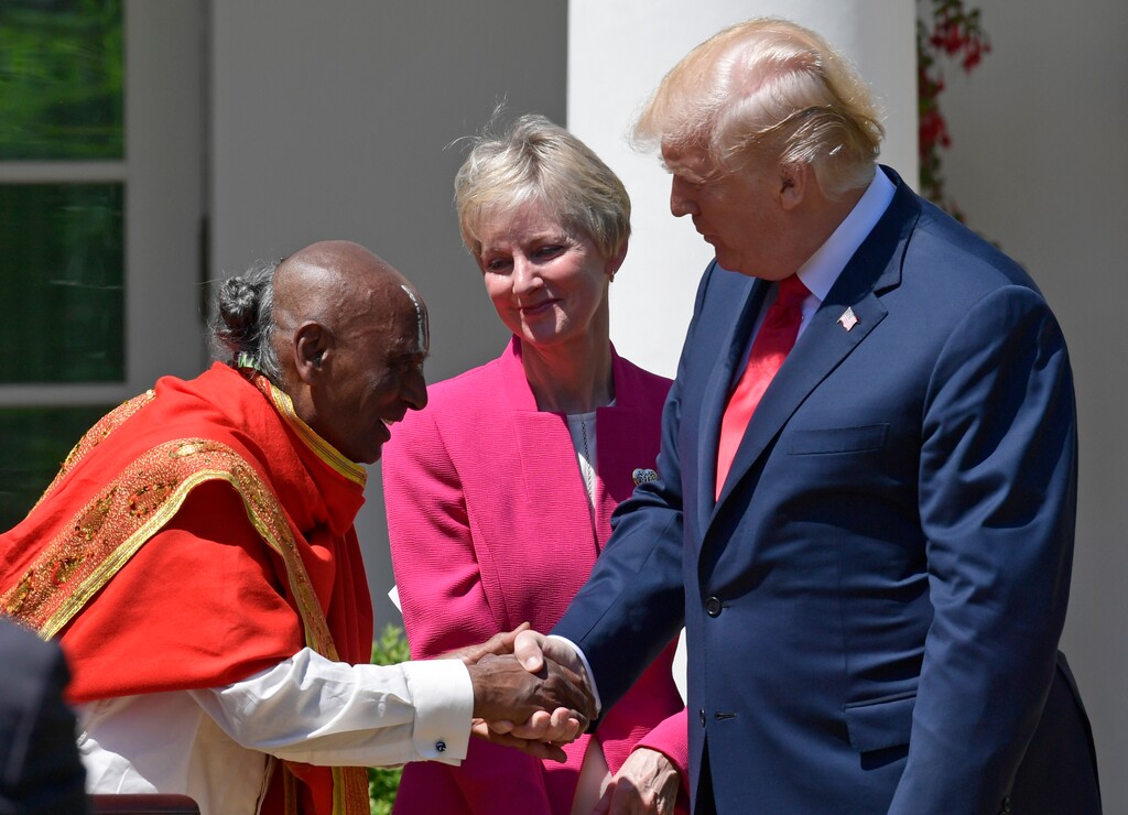 (Susan Walsh | AP file photo) President Donald Trump, right, shakes hands with Narayanachar Digalakote, priest at the Sri Siva Vishnu Temple in Lanham, Md., left, during a National Day of Prayer event in the Rose Garden of the White House in Washington, Thursday, May 3, 2018. Jean B. Bingham, general president of the Relief Society of The Church of Jesus Christ of Latter-day Saints, looks on from center.