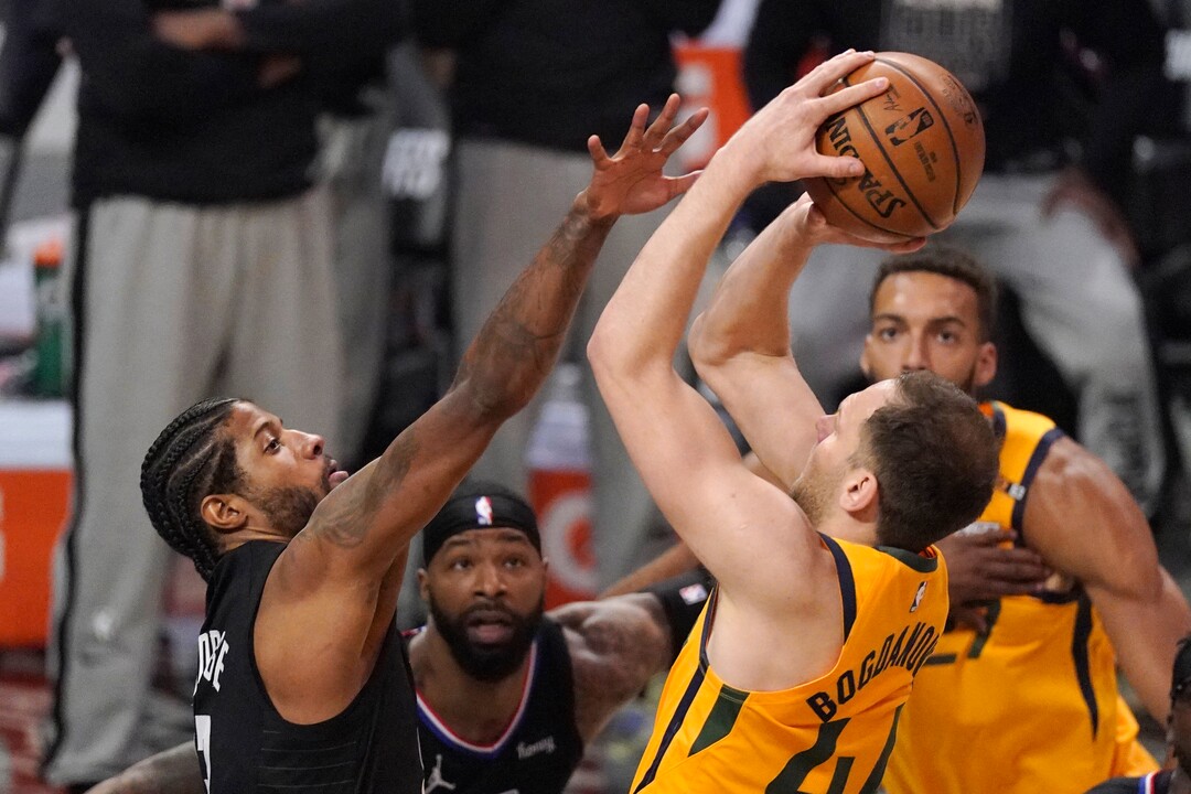 Utah Jazz forward Bojan Bogdanovic, right, shoots as Los Angeles Clippers guard Paul George defends during the first half in Game 4 of a second-round NBA basketball playoff series Monday, June 14, 2021, in Los Angeles. (AP Photo/Mark J. Terrill)