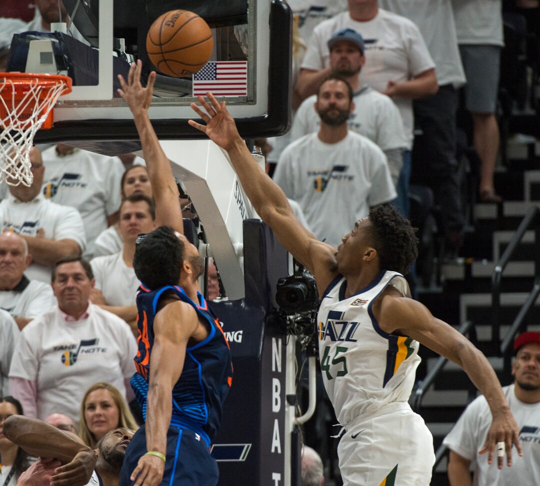 (Rick Egan  |  The Salt Lake Tribune) Utah Jazz guard Donovan Mitchell (45) scores over Oklahoma City Thunder guard Josh Huestis (34), in game 4, NBA playoff action between Utah Jazz and Oklahoma City Thunder, in Salt Lake City, Monday April 23, 2018.