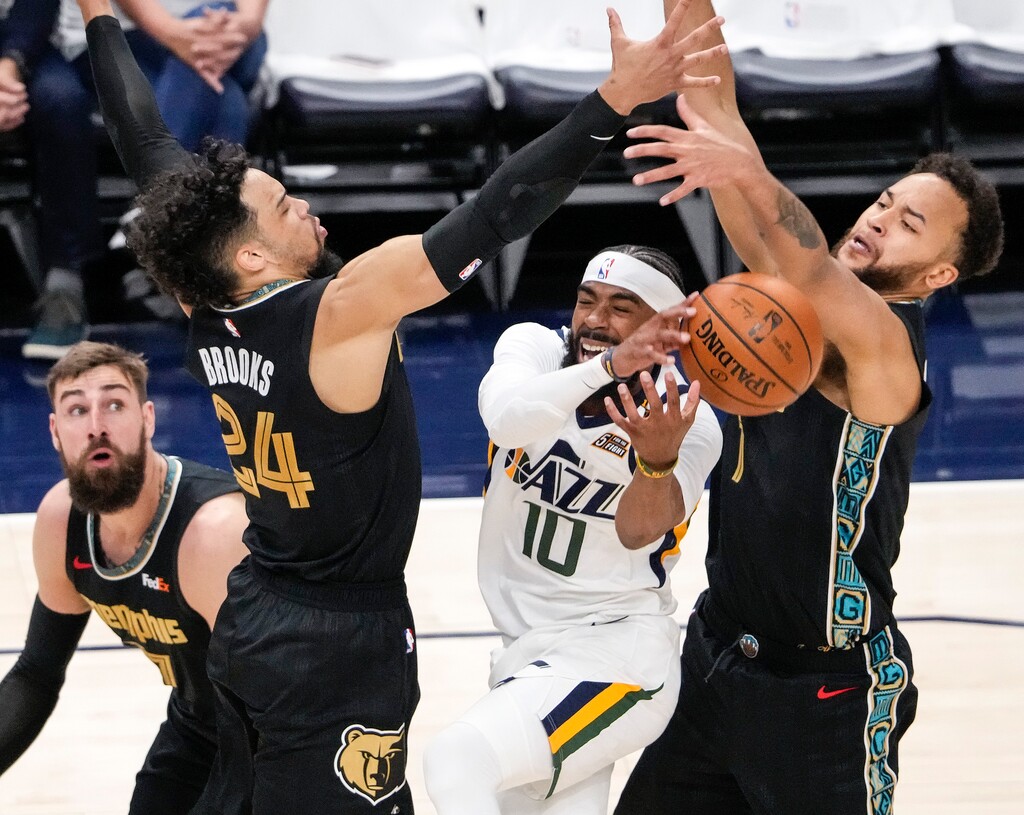 (Leah Hogsten | The Salt Lake Tribune) Utah Jazz guard Mike Conley (10) is heavily pressured at the net as the Utah Jazz take on the Memphis Grizzlies during Game 1 of the first-round playoffs at Vivint Arena, May 23, 2021. 