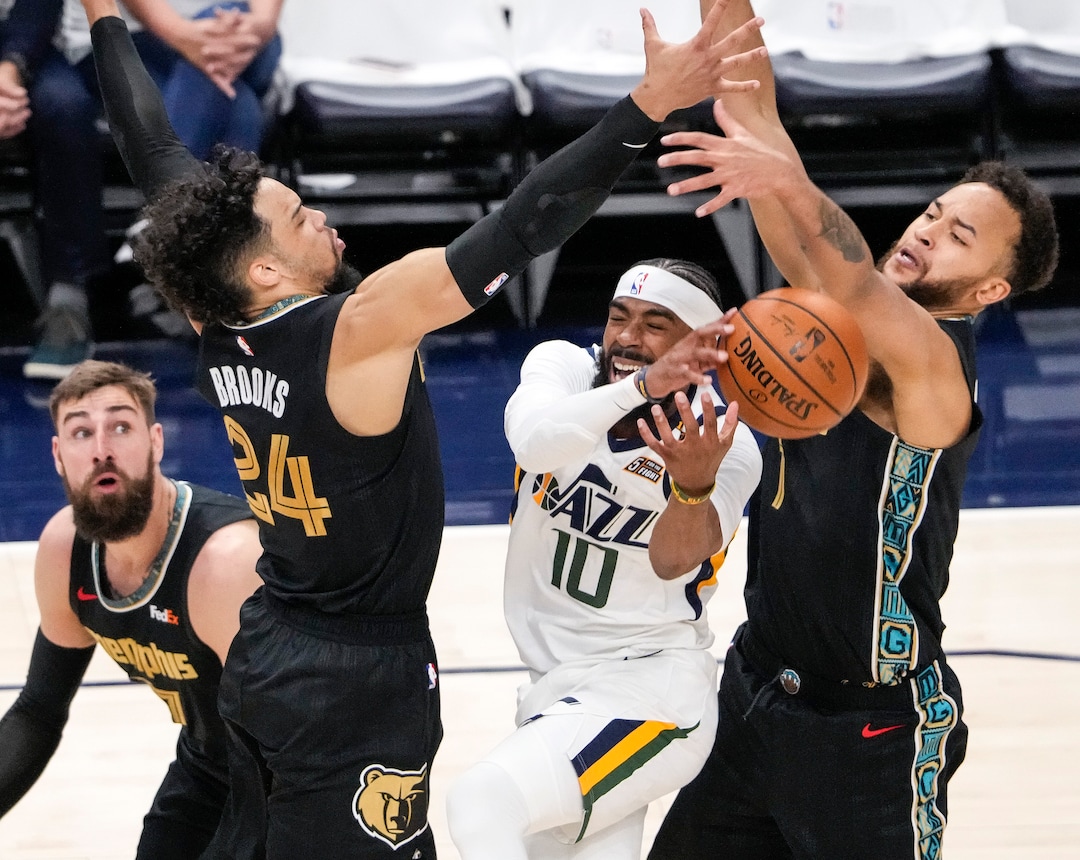 (Leah Hogsten | The Salt Lake Tribune) Utah Jazz guard Mike Conley (10) is heavily pressured at the net as the Utah Jazz take on the Memphis Grizzlies during Game 1 of the first-round playoffs at Vivint Arena, May 23, 2021.