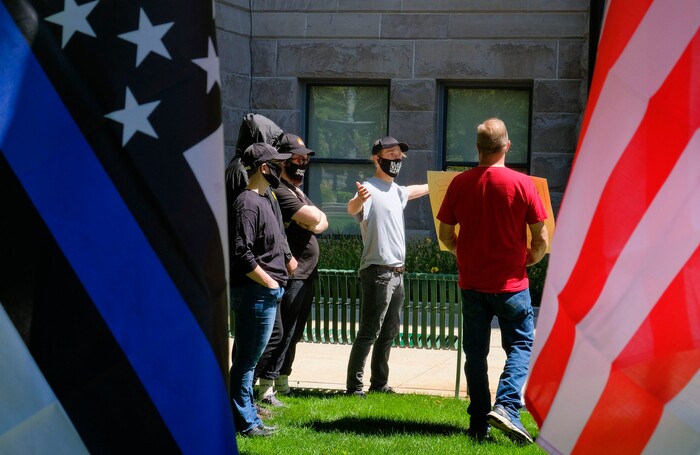(Leah Hogsten | The Salt Lake Tribune) For a brief moment, a Black Lives Matter supporter engaged with a Back the Blue supporter of law enforcement, Saturday, August 15, 2020 at Washington Square.