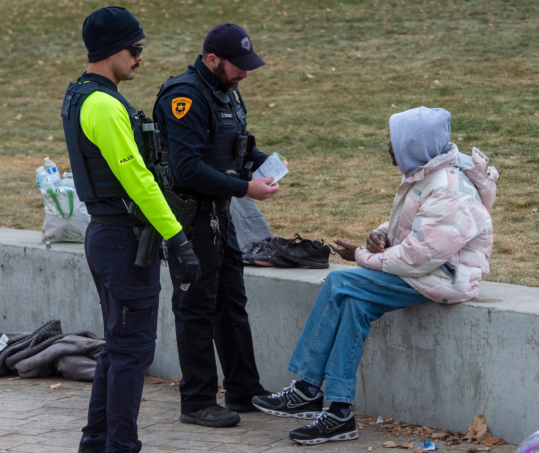 (Rick Egan | The Salt Lake Tribune) Salt Lake City Police give a citation to a man near the Salt Lake City Library, Monday, Dec. 23, 2019.