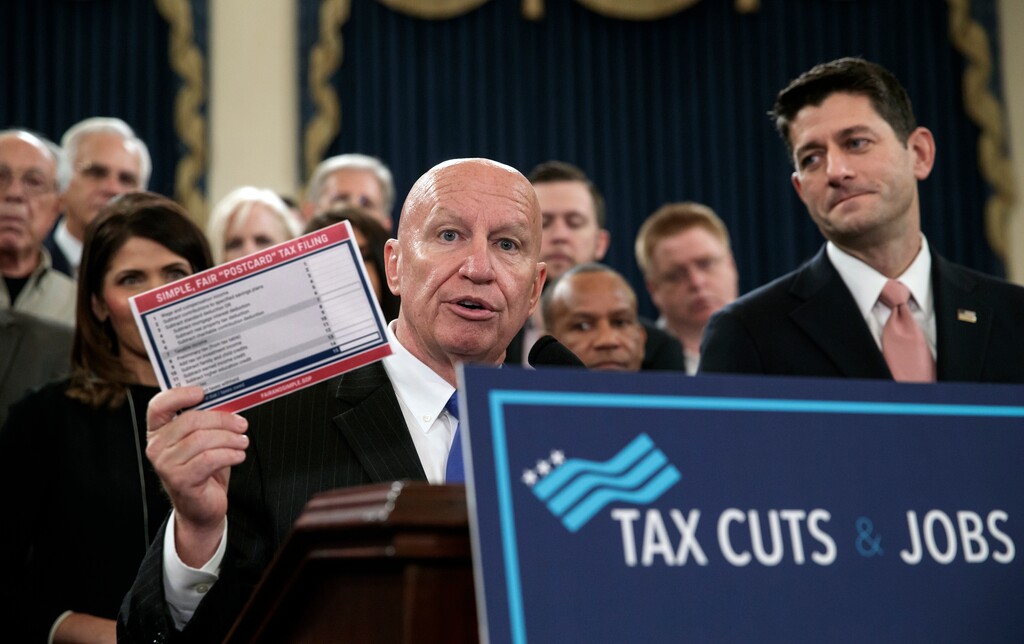 House Ways and Means Committee Chairman Kevin Brady, R-Texas, joined by Speaker of the House Paul Ryan, R-Wis., right, holds a proposed "postcard tax filing form" as they unveil the GOP's far-reaching tax overhaul, the first major revamp of the tax system in three decades, on Capitol Hill in Washington, Thursday, Nov. 2, 2017. (AP Photo/J. Scott Applewhite)