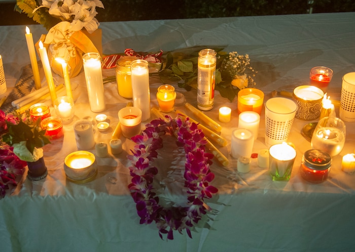(Rick Egan  |  The Salt Lake Tribune)       BYU students place flowers and candles at the entrance of the Tanner building during a candlelight vigil on BYU campus, for the student who died by suicide this week, Friday, Dec. 7, 2018.
  
