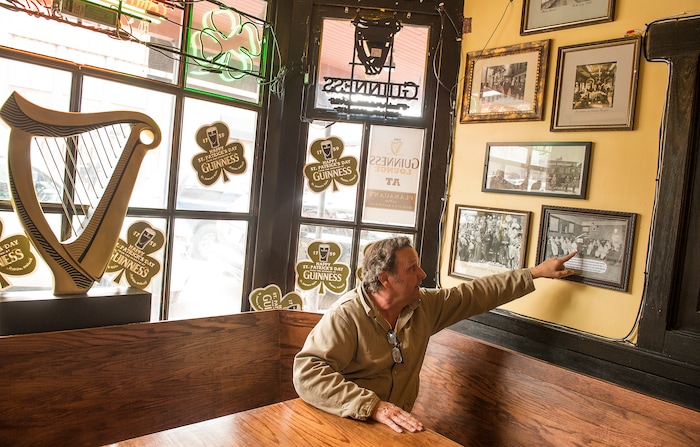 Leah Hogsten | The Salt Lake Tribune
John Kenworthy, owner of Flanagan's on Main, points out his grandfather in the photos that adorn the walls of the Irish Pub in Park City.