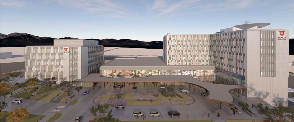 A computer-generated image shows two large, light gray buildings connected by a lower level with landscaping and cars around them.
