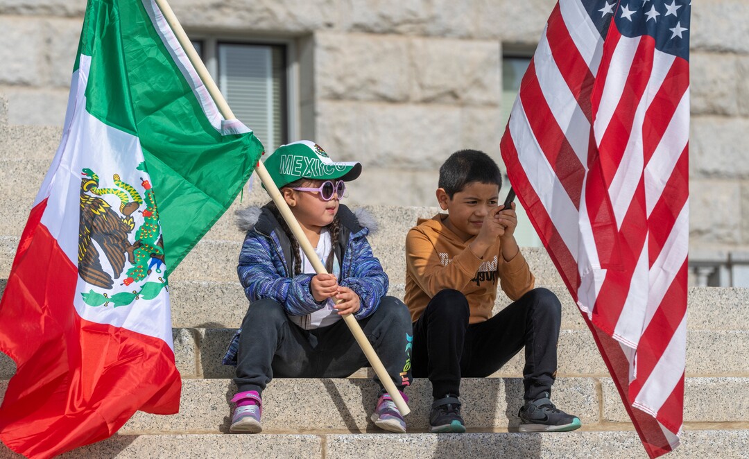 (Rick Egan | The Salt Lake Tribune)  Kendra and Jessy Martinezhold flags as they sit on the steps of the Capitol, for the national Day Without Immigrants rally, on Monday, Feb. 14, 2022.