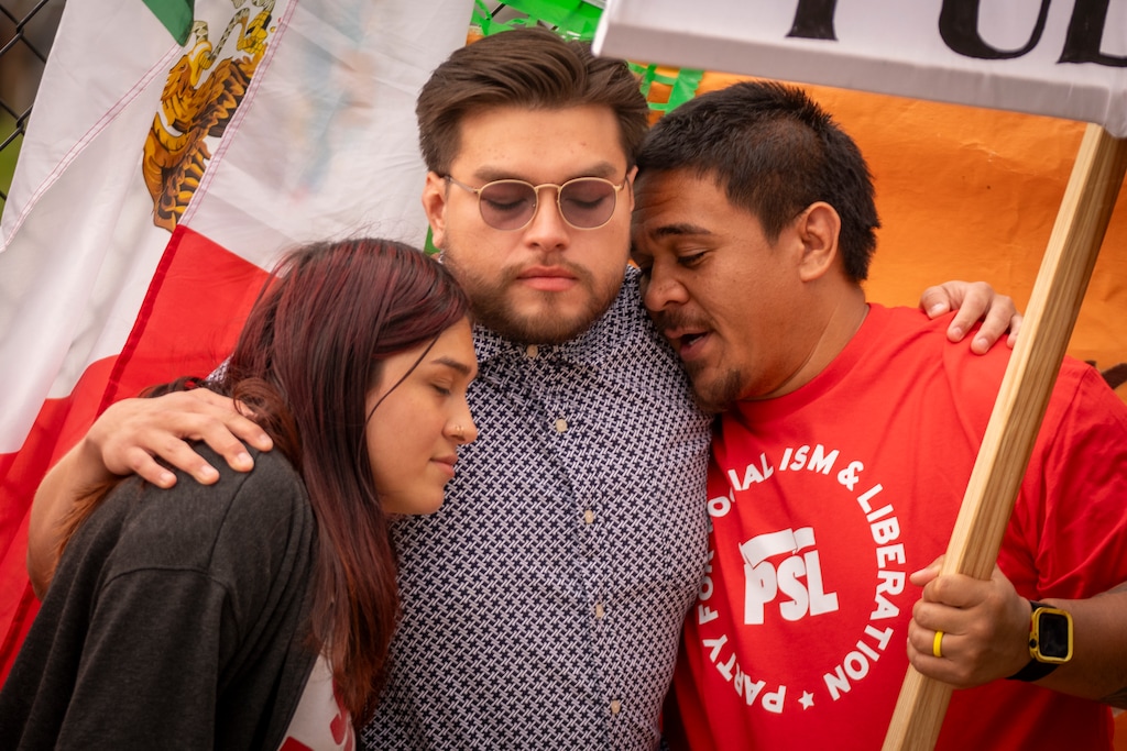 (Rick Egan | The Salt Lake Tribune)  Chantal and Julio Irungaray Jr., left and center, get a hug during a community gathering in support of their father, Julio Irungaray, on Thursday evening.