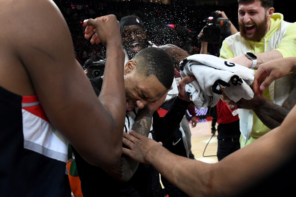 (Steve Dykes | AP) Portland Trail Blazers guard Damian Lillard, center, is doused by teammates after setting franchise and career highs with 71 points during an NBA basketball game against the Houston Rockets in Portland, Ore., Sunday, Feb. 26, 2023.