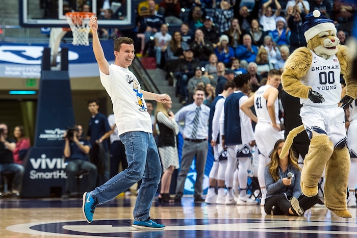 (Chris Detrick  |  The Salt Lake Tribune)  Brigham Young Cougars freshman Christopher McLeod celebrates after making a half-court shot to win $9,000 during the game at the Marriott Center Thursday, December 21, 2017.  