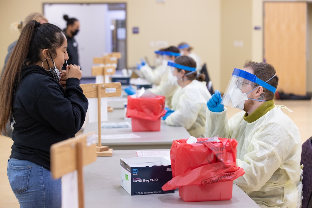 (Photo courtesy of Weber State University) Jacqueline Perez, left, self-administers a COVID-19 test in front of Avery Lytle during the first day of the free asymptomatic COVID-19 testing for students and employees at the Shepherd Union building, in Ogden on Tuesday, November 10, 2020.