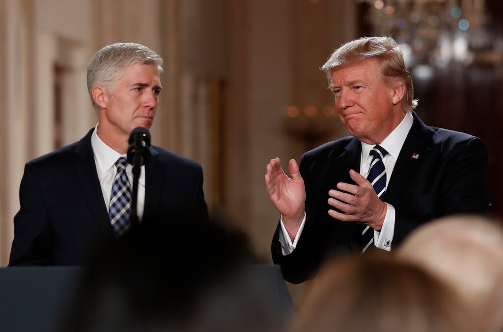 (Carolyn Kaster | The Associated Press) President Donald Trump applauds as he stands with Judge Neil Gorsuch in East Room of the White House in Washington, Tuesday, Jan. 31, 2017, after announcing Gorsuch as his nominee for the Supreme Court.