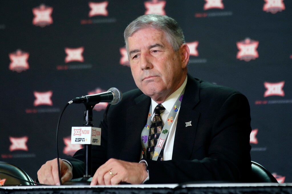 FILE - In this March 11, 2020, file photo, Big 12 Commissioner Bob Bowlsby announces no fans will be admitted to the rest of the Big 12 basketball tournament in Kansas City, Kan. As virus disruptions mount and the Dec. 19 end of college football's regular season draws closer, the possibility grows that conference championships, major awards and even College Football Playoff participants will be determined by COVID-19. “If you’d asked me in July if we’d have gotten this many games in, I wouldn’t have wanted to bet a lot of money on it,” Big 12 Commissioner Bob Bowlsby said. (AP Photo/Orlin Wagner, File)