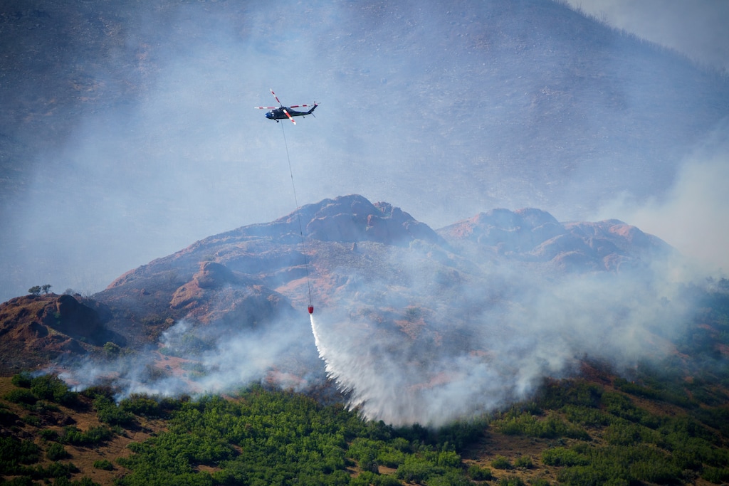(Trent Nelson | The Salt Lake Tribune) A helicopter makes a drop on the East Canyon Fire as it burns north of East Canyon State Park, on Tuesday, June 8, 2021.