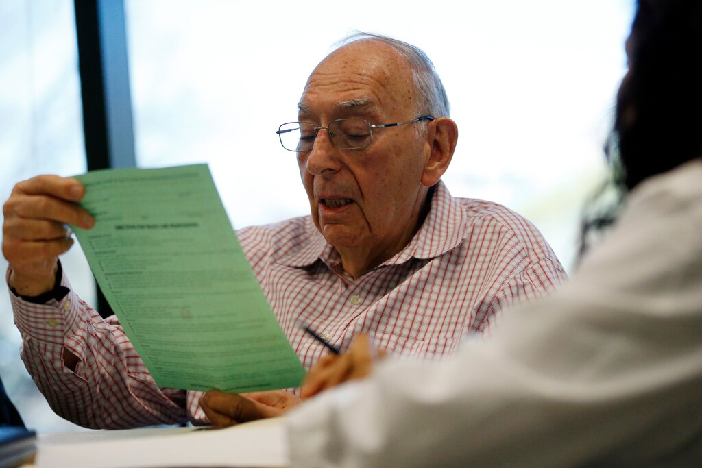 In this Wednesday, April 13, 2016 photo, Herbert Diamond, 88, of Fort Lee, N.J., meets with Dr. Manisha Parulekar about his end of life preferences at the Hackensack Medical Center in Hackensack, N.J. For years before the Affordable Care Act was written, there was bipartisan consensus on the value in helping people understand their desires at the end of their lives and make those wishes known. A 1991 law passed under President George H.W. Bush requires hospitals and nursing homes to help patients who want to prepare living wills and advance directives. (AP Photo/Julio Cortez)