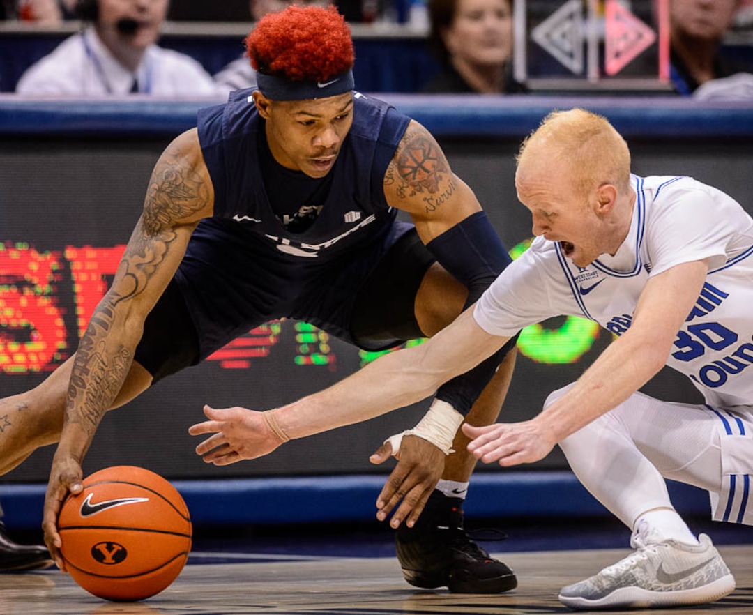 (Trent Nelson | The Salt Lake Tribune)  Brigham Young Cougars guard TJ Haws (30) dives in to try to take the ball from Utah State Aggies guard John Knight III (3) as BYU hosts Utah State, NCAA basketball in Provo on Wednesday Dec. 5, 2018.