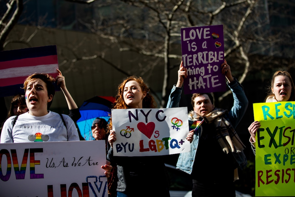 (Demetrius Freeman | Special to The Tribune) Maddie Hall, 25, center, chants with current and former members of The Church of Jesus Christ of Latter-day Saints, the LGBTQ+ community, and supporters protest at Lincoln Square across from the Latter-day Saints temple in Manhattan on Saturday, March 7, 2020. BYU reinstated policies in its student handbook that prohibit "homosexual behavior."
