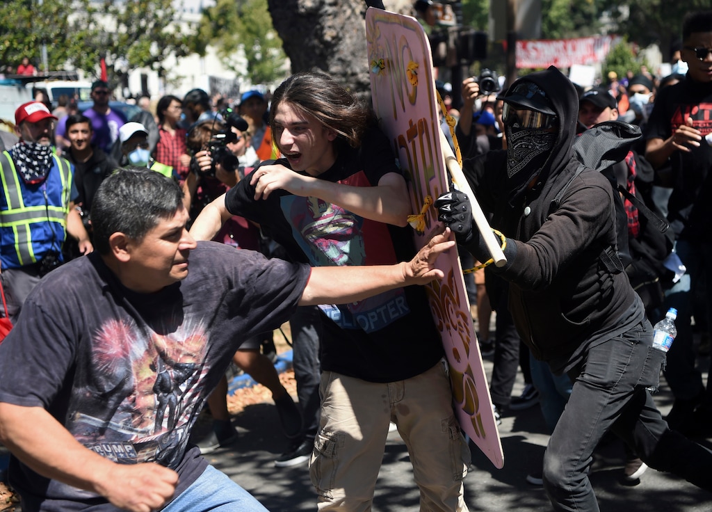 Demonstrators clash during a free speech rally Sunday, Aug. 27, 2017, in Berkeley, Calif. Several thousand people converged in Berkeley Sunday for a "Rally Against Hate" in response to a planned right-wing protest that raised concerns of violence and triggered a massive police presence. Several people were arrested for violating rules against covering their faces or carrying items banned by authorities. (AP Photo/Josh Edelson)