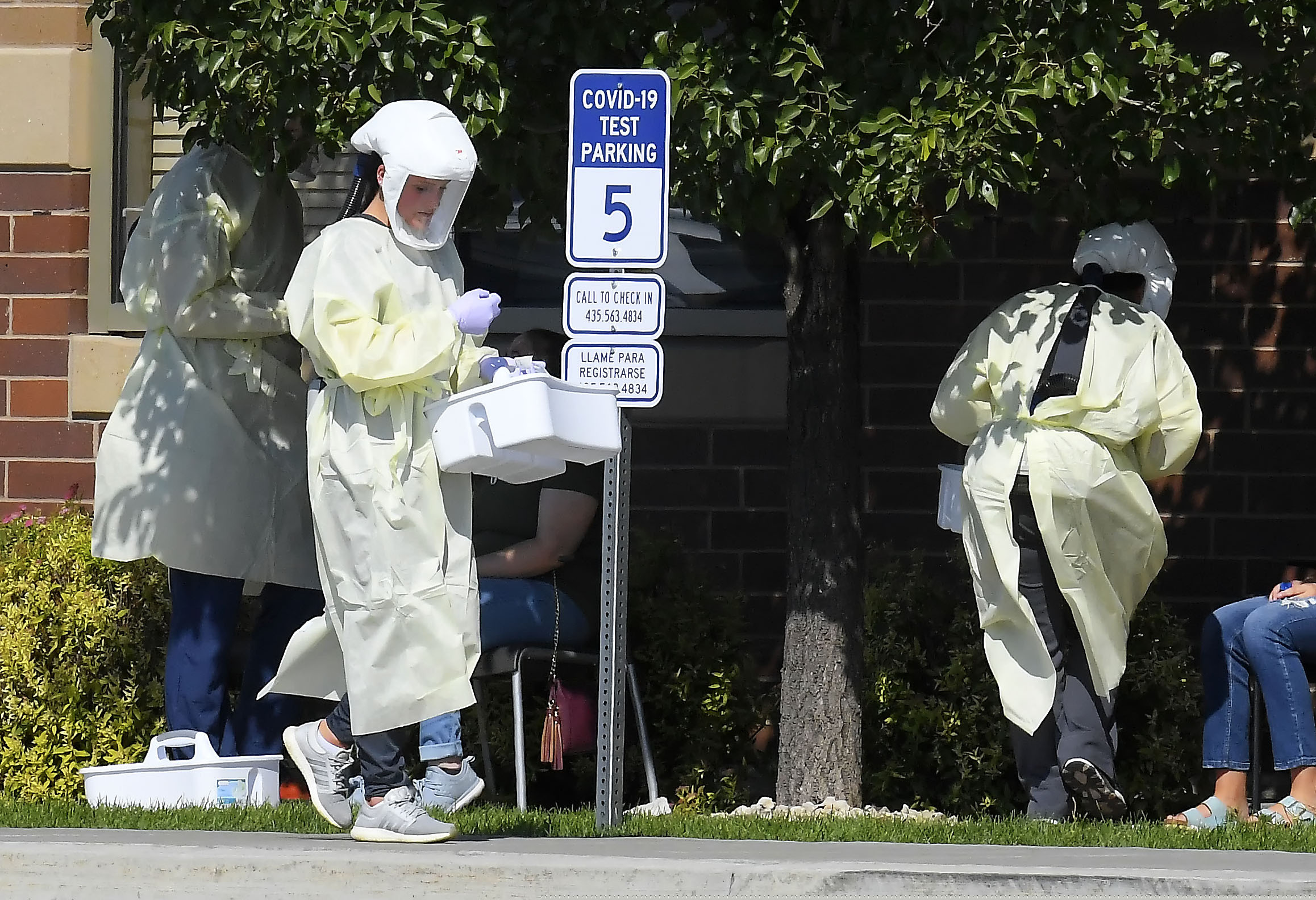 (Eli Lucero  |  The Herald Journal / AP) Workers test Utah State University students for COVID-19 on Sunday, Aug. 30, 2020, in Hyde Park, Utah.