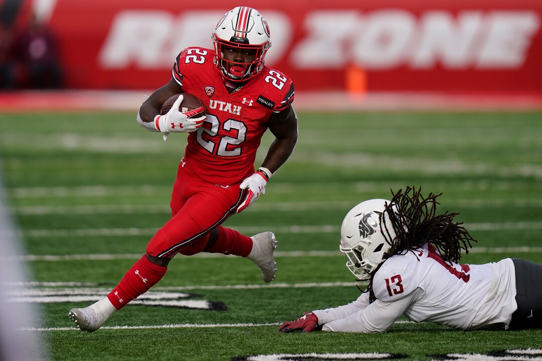 (Rick Bowmer | AP file photo) In this Dec. 19, 2020, file photo, Utah running back Ty Jordan (22) runs for a score as he eludes a tackle by Washington State linebacker Jahad Woods (13) during the second half of an NCAA college football game in Salt Lake City. Jordan was selected as the PAC-12 newcomer of the year. Jordan died this week in Texas.