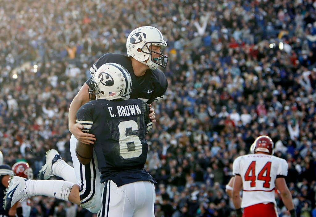 (Chris Detrick | The Salt Lake Tribune) BYU quarterback John Beck leaps into the arms of Curtis Brown after a touchdown against Utah in 2005. Beck threw for 309 yards with two touchdowns. Beck has been hired by the New York Jets to be the personal QB coach to No. 2 overall draft pick Zach Wilson.