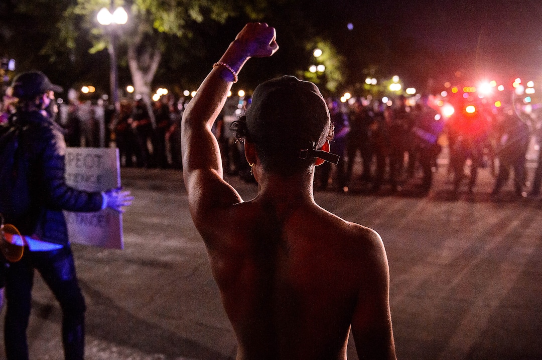 (Trent Nelson  |  The Salt Lake Tribune)  Protesters confront a line of police after a protest against police brutality turned violent in Salt Lake City on Saturday, May 30, 2020.