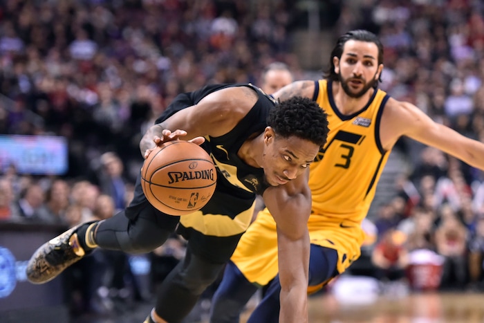 Toronto Raptors guard DeMar DeRozan drives around Utah Jazz guard Ricky Rubio (3) during the second half of an NBA basketball game Friday, Jan. 26, 2018, in Toronto. (Frank Gunn/The Canadian Press via AP)