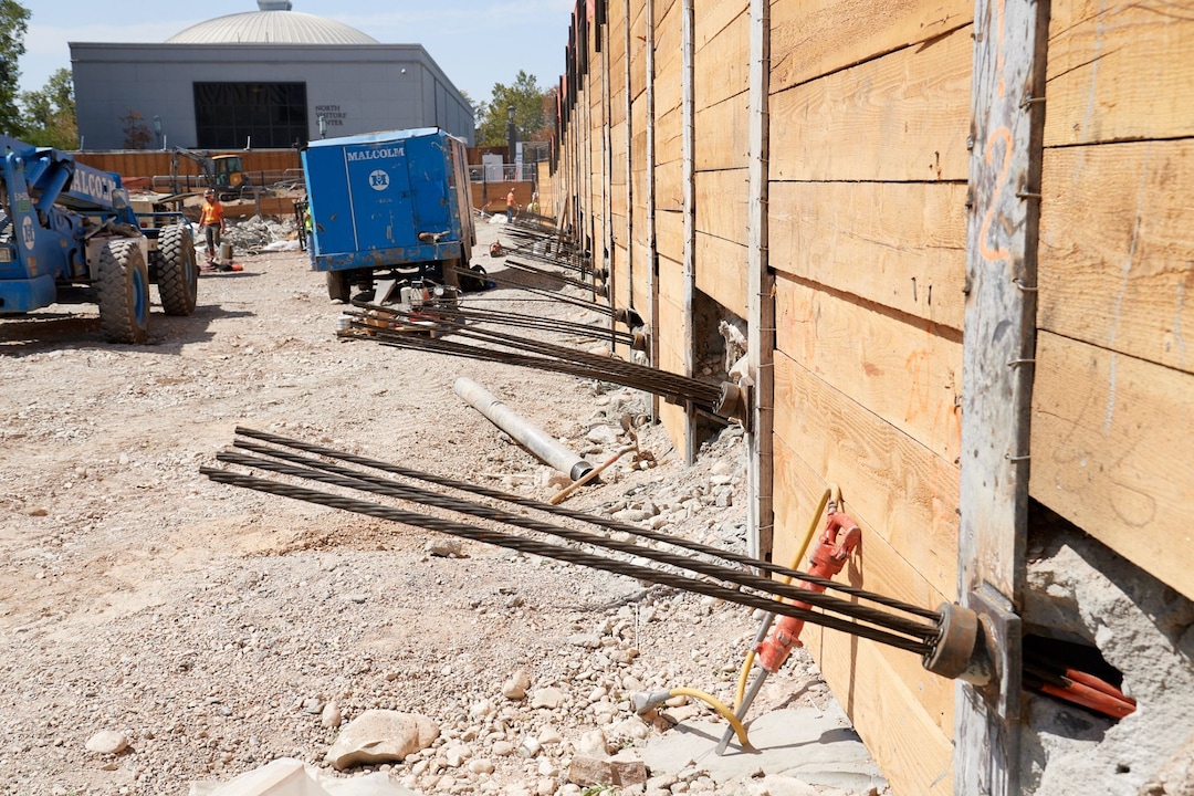 (Photo courtesy The Church of Jesus Christ of Latter-day Saints) The cables photographed here are stretched with tension by a machine to provide additional stability to this retaining wall of four-inch-thick wood lagging. The wall will eventually span the entire perimeter of the temple grounds at a depth of 40 feet once excavation is complete.
