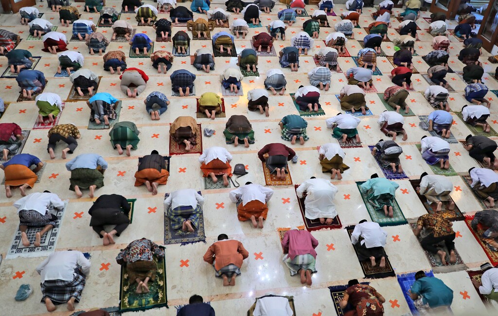 (Trisnadi | AP Photo) Indonesian Muslims pray spaced apart as they practice social distancing to curb the spread of the new coronavirus during an Eid al-Fitr prayer marking the end of the holy fasting month of Ramadan in Sidoarjo, East Java, Indonesia, Sunday, May 24, 2020.