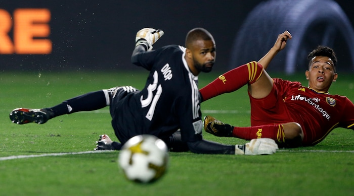 Real Salt Lake midfielder Sebastian Saucedo, right, and Los Angeles Galaxy goalkeeper Clement Diop watch Saucedo's shot go wide of the goal pole during the second half of an MLS soccer game in Carson, Calif., Saturday, Sept. 30, 2017. (AP Photo/Alex Gallardo)