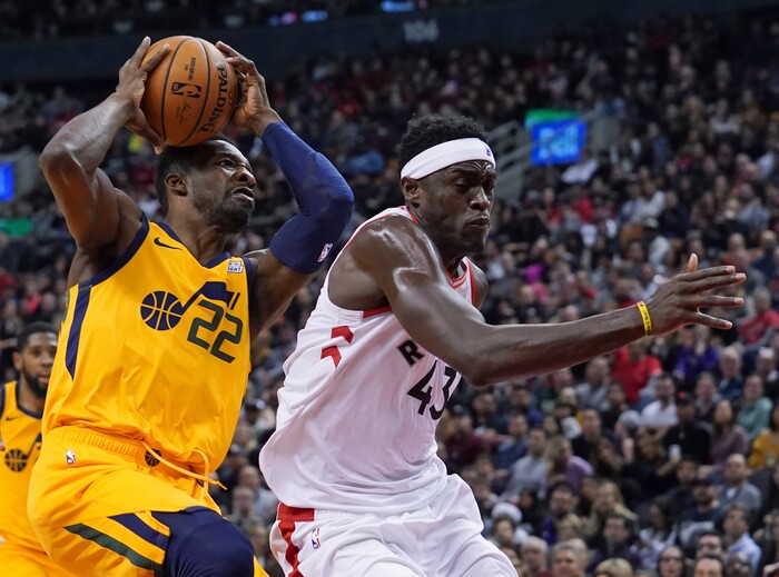 Utah Jazz's Patrick McCaw (22) collides with Toronto Raptors' Pascal Siakam (43) during first half NBA basketball action in Toronto, Sunday, Dec. 1, 2019. (Hans Deryk/The Canadian Press via AP)