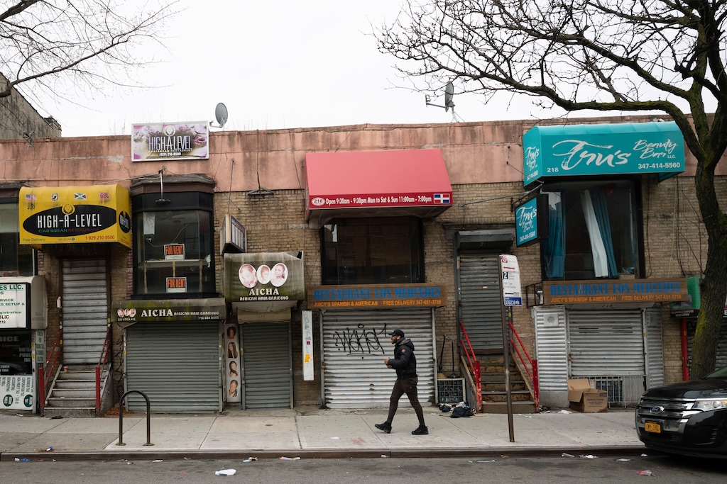 In this April 8, 2020, photo, small businesses are shuttered closed during the coronavirus epidemic in the Crown Heights neighborhood of the Brooklyn borough in New York. For years, financial inequality has widened in the United States and elsewhere as wealth and income have become increasingly concentrated among the most affluent while millions struggle to get by. Now, the coronavirus outbreak has laid bare the human cost of that inequality, making it more visible and potentially worse. (AP Photo/Mark Lennihan)