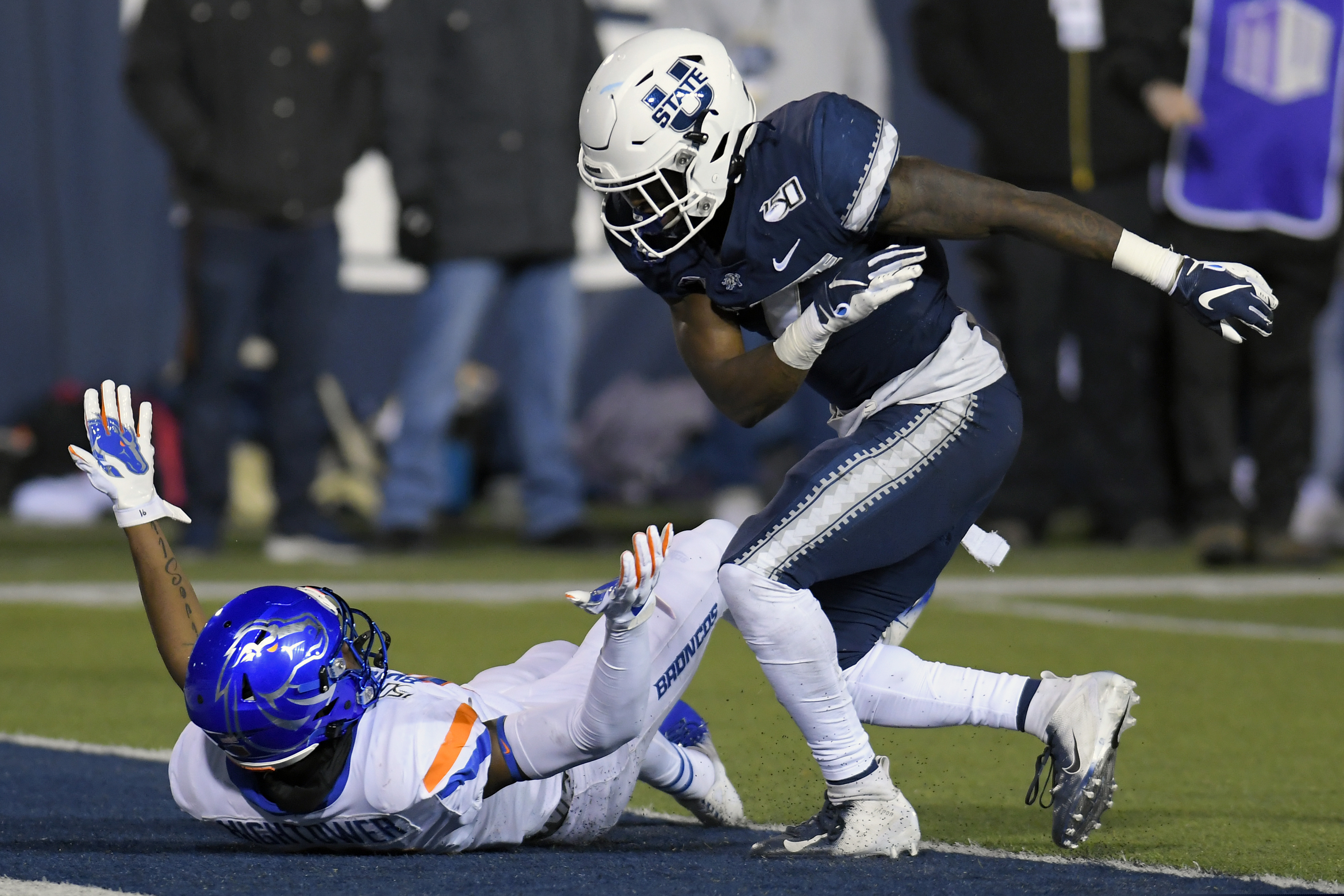 Utah State cornerback DJ Williams, right, throws Boise State wide receiver John Hightower to the ground after the play was over during the first half of an NCAA college football game Saturday, Nov. 23, 2019, in Logan, Utah. Both players received an unsportsmanlike-conduct penalty; it was Williams' second of the game and he was ejected. (AP Photo/Eli Lucero)