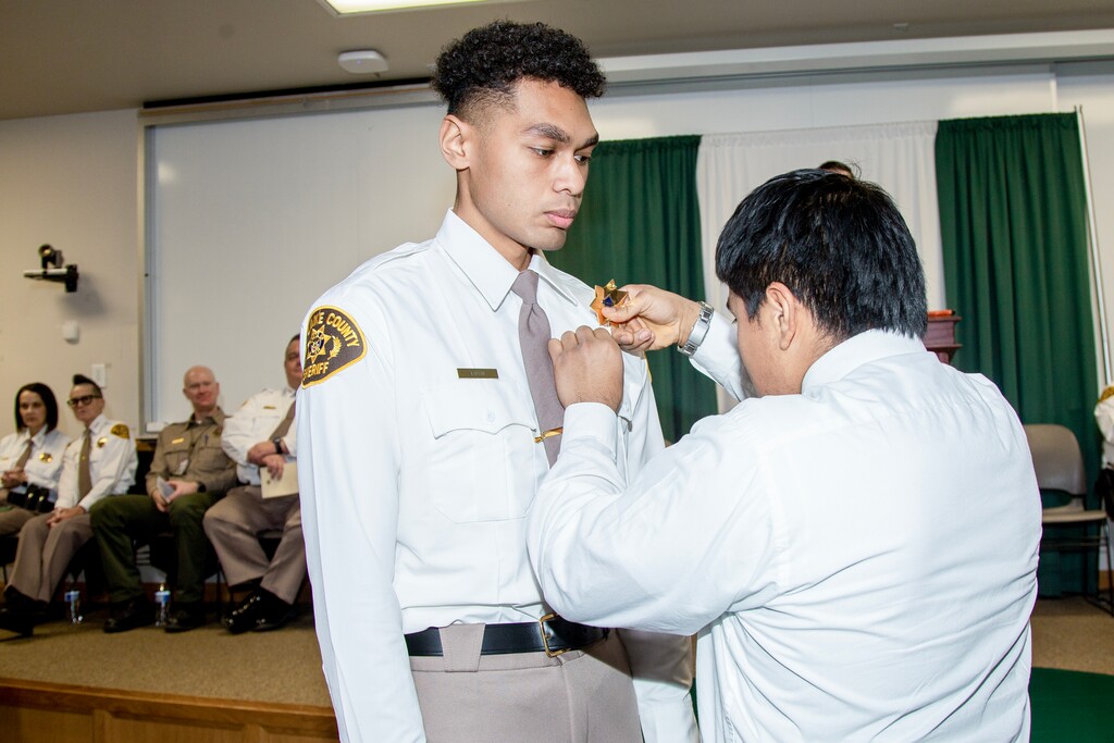(Salt Lake County Sheriff's Office) Emaloni Takitoa Lutui, 20, is presented with a badge at his Salt Lake County Sheriff's Office academy graduation on Jan. 11, 2024. Lutui died Monday, Jan. 29, 2024, while rescuing a woman who fell through ice at Settlement Canyon Reservoir in Tooele County.