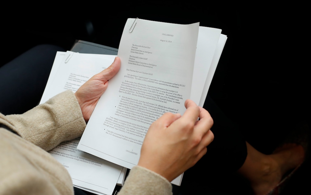 (Pablo Martinez Monsivais | AP) A member of the audience holds a copy of the Whistle-Blower Complaint letter sent to Senate and House Intelligence Committees during testimony by Acting Director of National Intelligence Joseph Maguire before the House Intelligence Committee on Capitol Hill in Washington, Thursday, Sept. 26, 2019.