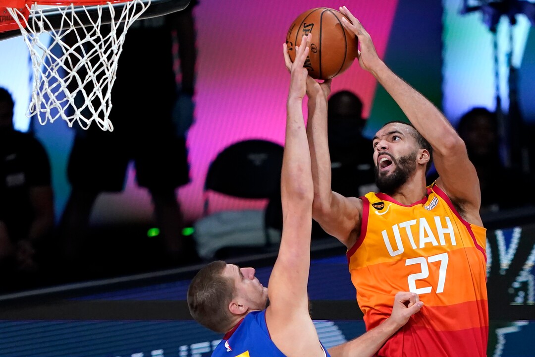 Utah Jazz's Rudy Gobert (27) goes up for a shot as Denver Nuggets' Nikola Jokic defends during the first half of an NBA basketball first round playoff game Sunday, Aug. 30, 2020, in Lake Buena Vista, Fla. (AP Photo/Ashley Landis)