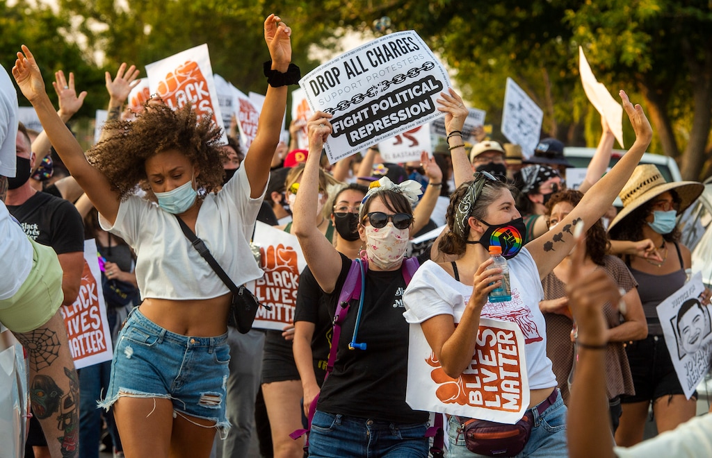 (Rick Egan  |  The Salt Lake Tribune)     Protesters dance through the neighborhood in Rose Park, during the Dance Dance for Revolution protest for racial equality, on Sunday, Aug. 23, 2020. The protest was in memory of Jovany Mercardo who was shot last August by Ogden police by four officers, hitting his body sixteen times.