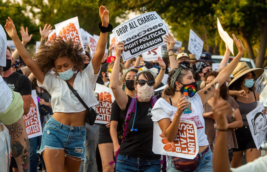 (Rick Egan  |  The Salt Lake Tribune)     Protesters dance through the neighborhood in Rose Park, during the Dance Dance for Revolution protest for racial equality, on Sunday, Aug. 23, 2020. The protest was in memory of Jovany Mercardo who was shot last August by Ogden police by four officers, hitting his body sixteen times.