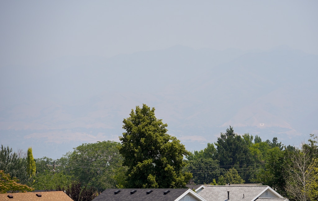 (Chris Samuels | The Salt Lake Tribune) Smoke obscures the Wasatch Front seen from West Valley City, Tuesday, June 23, 2026.
