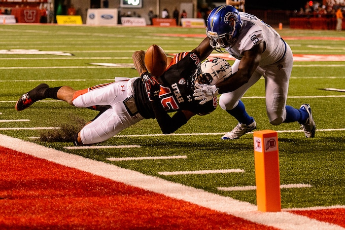 (Trent Nelson | The Salt Lake Tribune) Utah Utes wide receiver Raelon Singleton (11) loses his footing and the ball as San Jose State Spartans linebacker William Ossai (11) closes in as the Utah Utes host the San Jose State Spartans, NCAA football at Rice-Eccles Stadium in Salt Lake City, Saturday September 16, 2017.