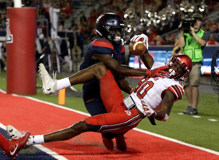 Arizona safety Demetrius Flannigan-Fowles defends the pass intended for Utah wide receiver Siaosi Wilson, right, during the first half of an NCAA college football game, Friday, Sept. 22, 2017, in Tucson, Ariz. Wilson was ruled out of bounds on the play. (AP Photo/Rick Scuteri)