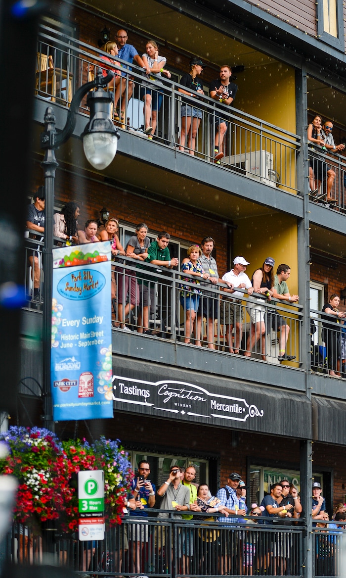Leah Hogsten | The Salt Lake Tribune Fans lining Park City's Main Street braved the downpour minutes prior to cyclists crossing the finish at the Tour of Utah's Stage 6, Sunday, August 12, 2018.
