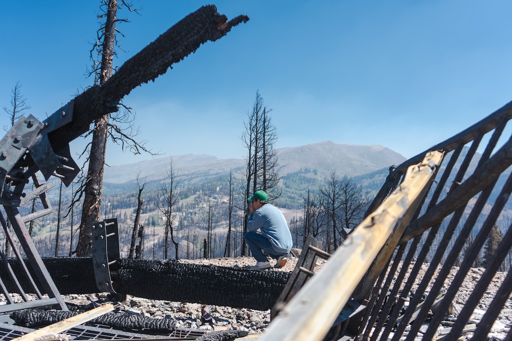 (Eagle Point Resort) Eagle Point Resort owner Shane Gadbaw takes in the destruction after the Cottonwood Fire burned through  the ski area near Beaver on June 22, 2026. The fire burned down the larger of its two day lodges and impacted four of five lifts and half of the resort's 600 acres.