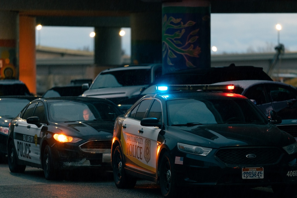 (Salt Lake City Police Department) Salt Lake City police respond to a crash scene on Monday, Dec. 12, 2022, beneath an Interstate 15 offramp near 545 West 600 South. A driver ran over a homeless man sleeping in the parking lot beneath the ramp just before 6 a.m.